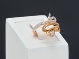 an image of a gold and silver ring with diamonds on a white box