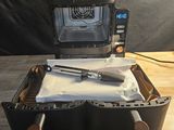 a toaster oven sitting on top of a table with a knife in it