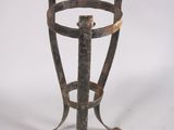 a small metal stand with a metal handle on it
