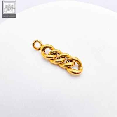 a close up of a gold plated chain link on a white surface
