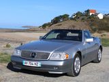 a silver car that is parked on the side of the road