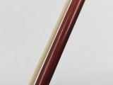 a close up of a wooden stick with a white background