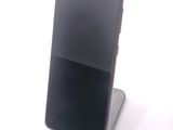 a cell phone that is sitting on top of a stand