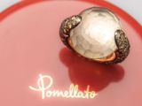 a ring with a white stone on a red plate