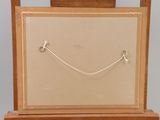 a picture of a wooden easel with a painting on it