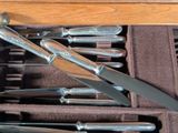 a bunch of knives in a case on the table
