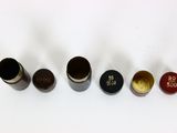 several different types of lipstick are lined up on a white surface