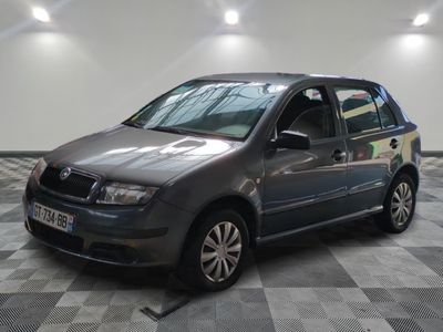 a picture of a grey car parked in a garage