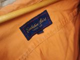 an orange jacket with a blue label on the back of it
