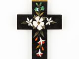 an image of a cross decorated with flowers and leaves on a white background