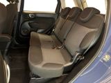 the interior of a small car with two rows of seats in it