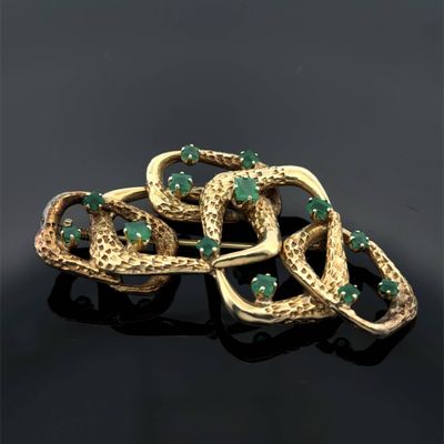 a gold and emerald broochle broochle
