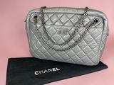 a chanel silver quilted leather handbag with chain strap
