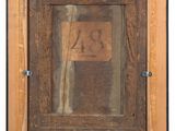 an old picture of a wooden frame with a number on it