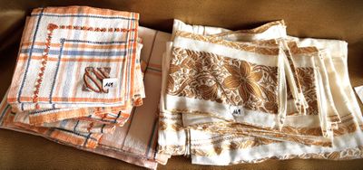 several pieces of cloth sitting on top of a couch next to each other