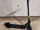 a scooter that is parked in front of a garage