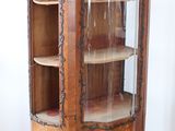 a wooden cabinet with a glass door in the corner