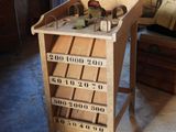a wooden table with a lot of drawers on top of it