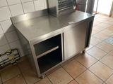 a stainless steel counter in a kitchen with tile flooring