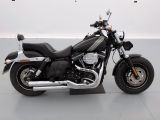 a picture of a black motorcycle parked in a garage