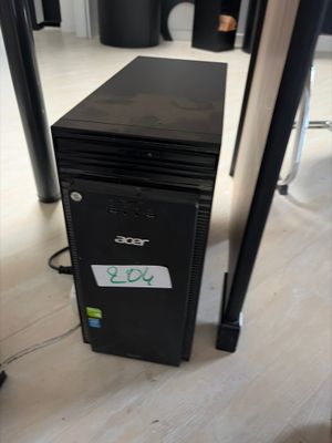 a small black computer sitting on the floor in a room