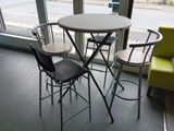 une table et quatre chaises devant une fenêtre