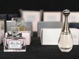 bottles of perfume sitting on a table next to boxes of perfume