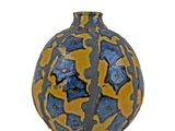 a blue and yellow vase sitting on a white surface
