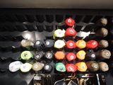 many different colored hats on a rack in a room