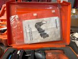 an orange case with tools in it sitting on a table