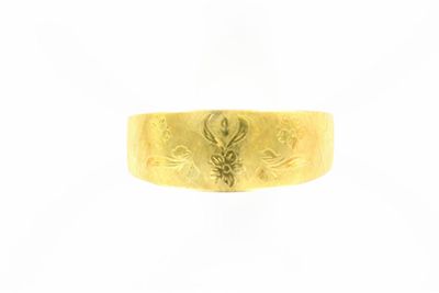 un gros plan d'une bague en or ornée d'un dragon