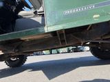 a man sitting in the back of a green truck