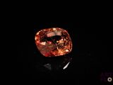 an orange diamond on a black surface