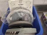 a blue basket filled with electronic equipment on top of a counter