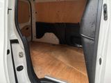 a white van with the door open on a hard wood floor