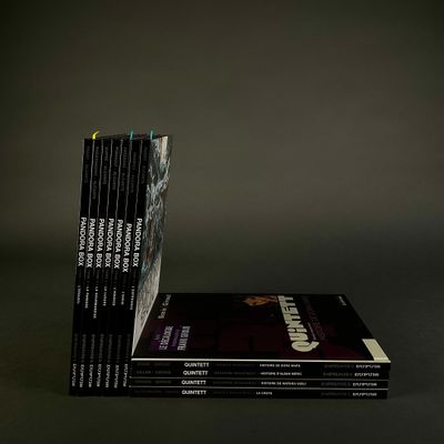 books stacked on top of each other on a black surface