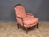 an old fashioned chair with a pink upholstered upholstered seat