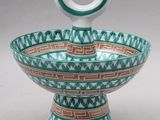 an image of a green and white bowl sitting on top of a table