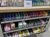 a lot of pens and pencils on the shelves in the store