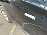 a black car with a sticker on it parked in a parking lot