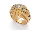 a close up of a gold and diamond ring on a white background