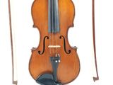 an old violin sitting next to a bow on a white surface