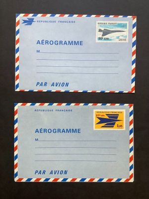two airmail envelopes with airmail stamps on them sitting on a table