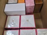 several boxes of various types of jewelry are in a cardboard box