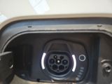 a close up of a car ' s fuel tank with a car plugged in