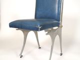 a blue chair that is on wheels on a white background