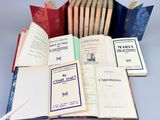 several old books are stacked on top of each other on a table