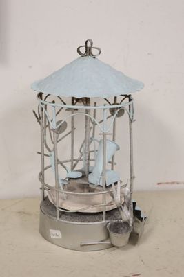 a bird cage with a bird inside of it on a table