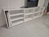 a white entertainment center with a flat screen tv on top of it