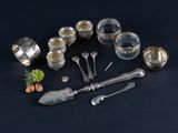 a lot of silverware on a black table